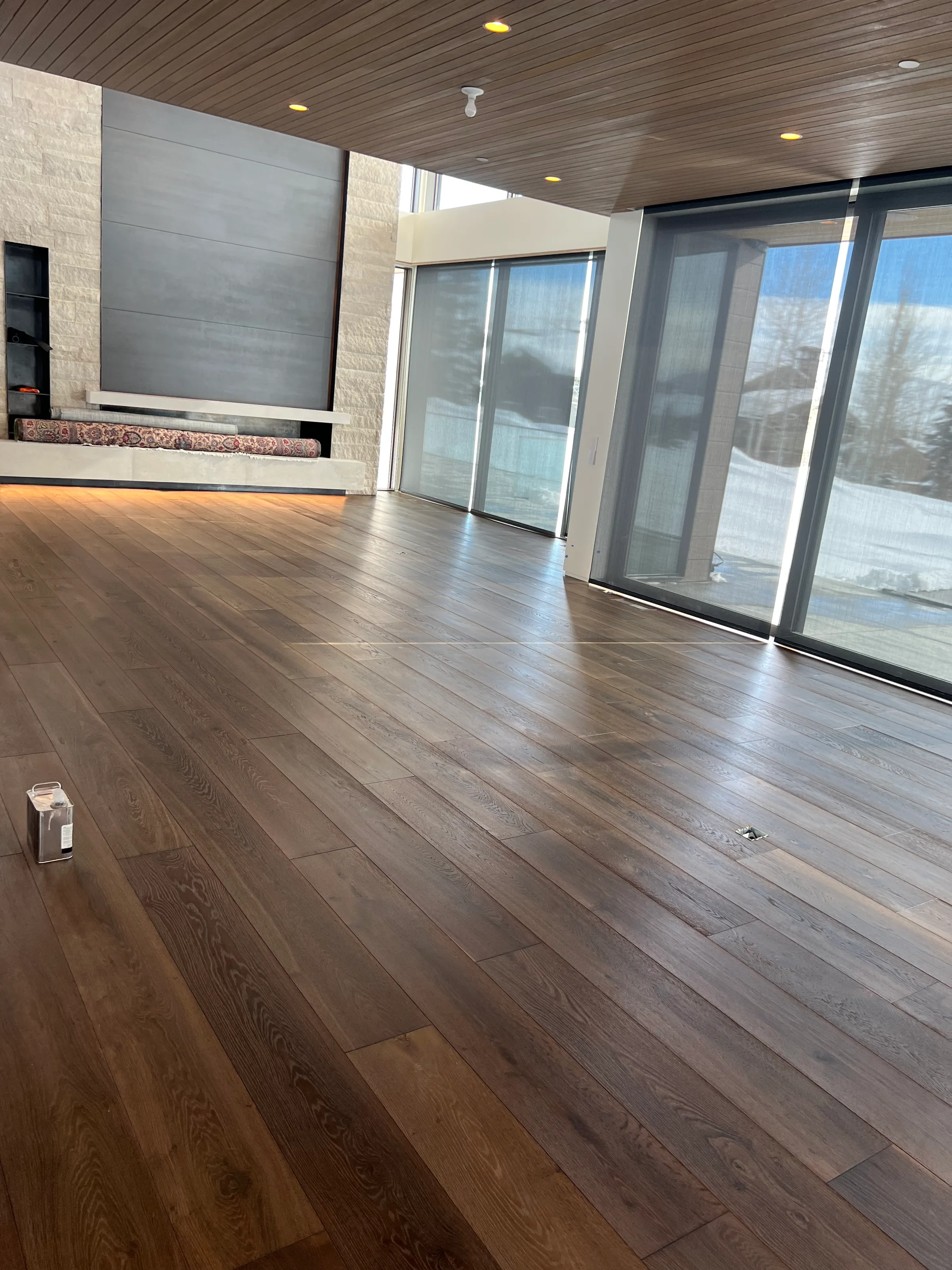 Pre-finished white oak flooring installation with factory finish showing light grain and neutral warmth