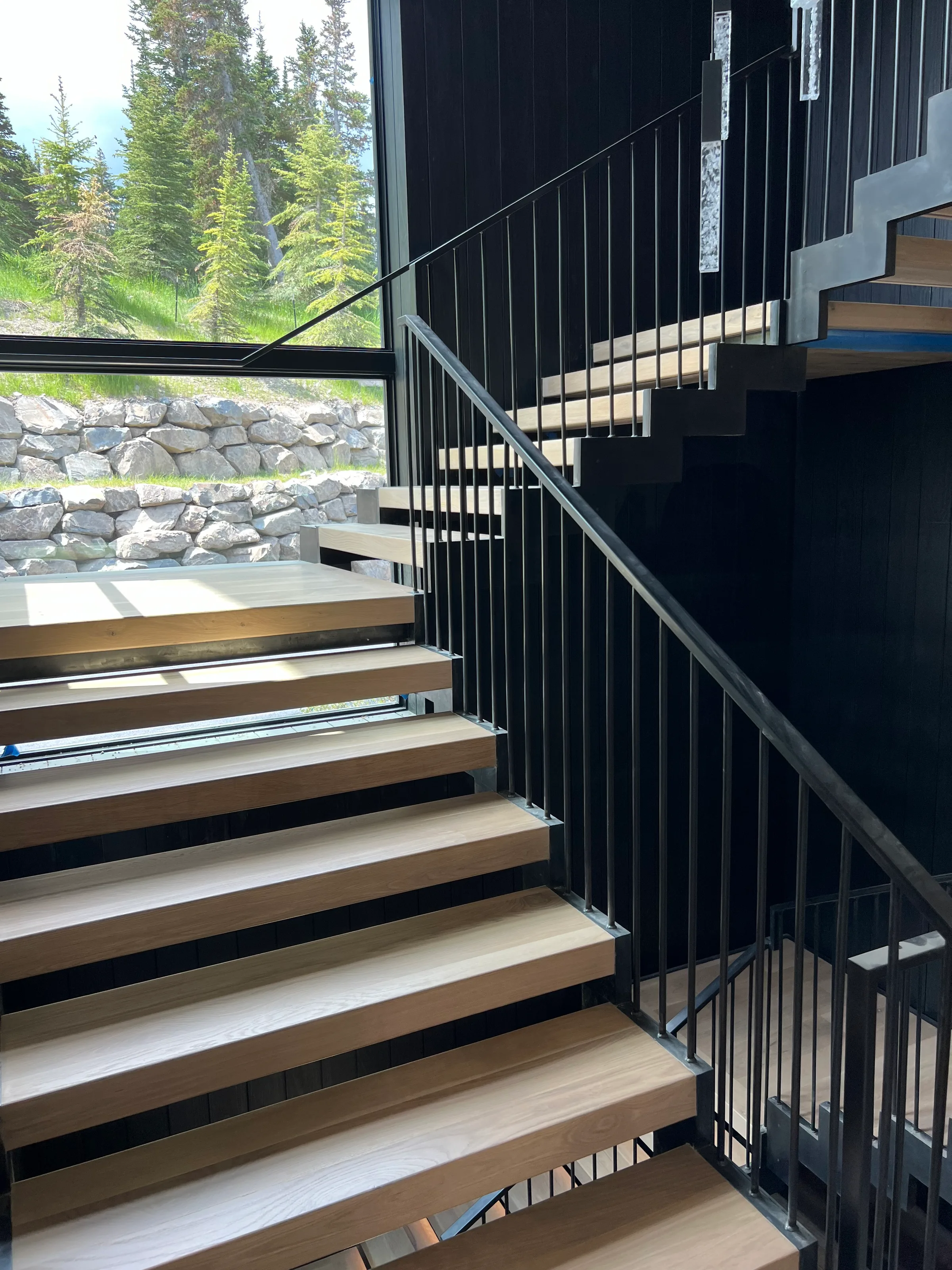 White oak wood suspended staircase treads with natural grain visible in bright space with overhead skylights
