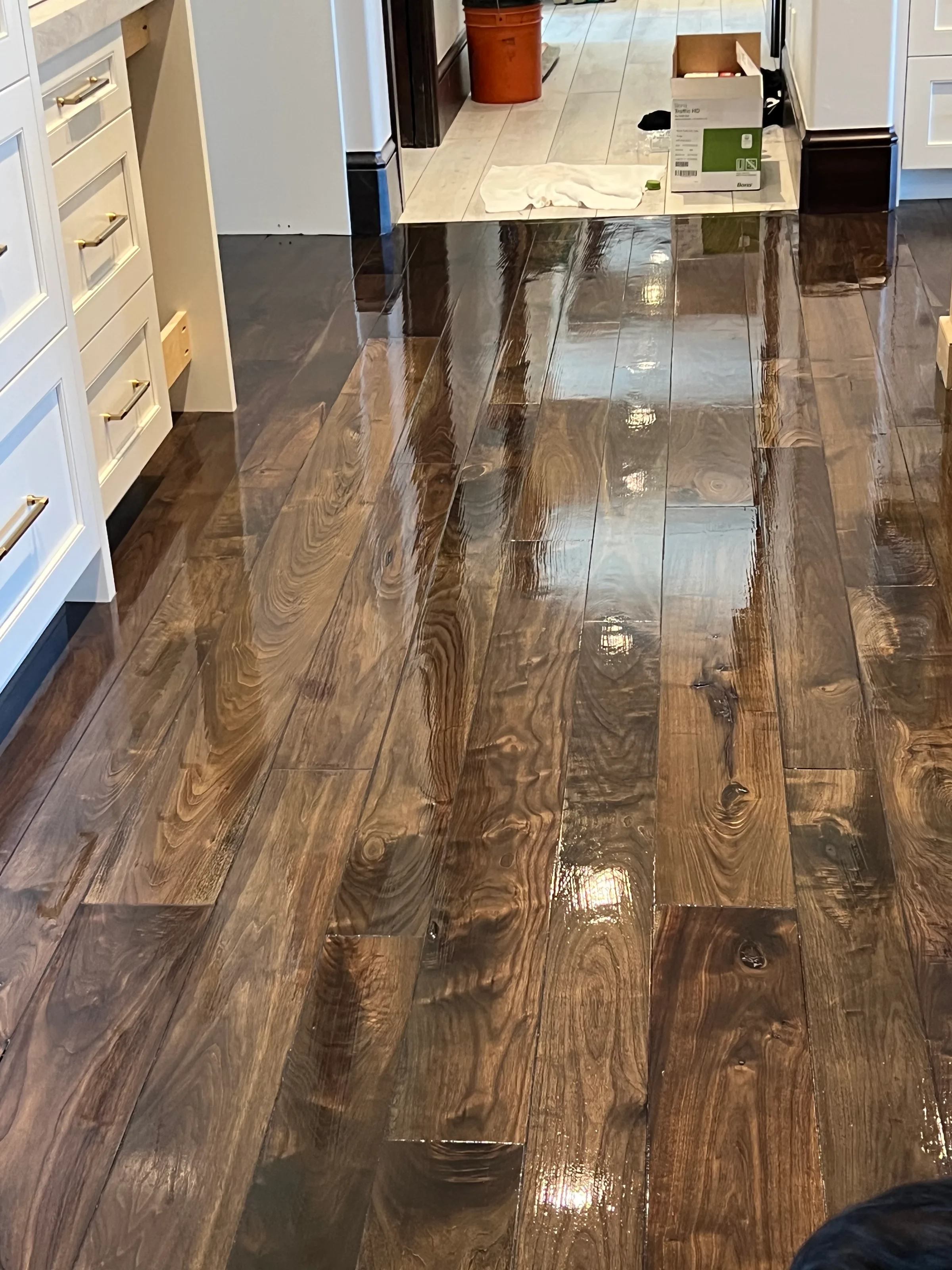 Refinished walnut flooring with beveled edge detailing enhancing grain and dimension throughout