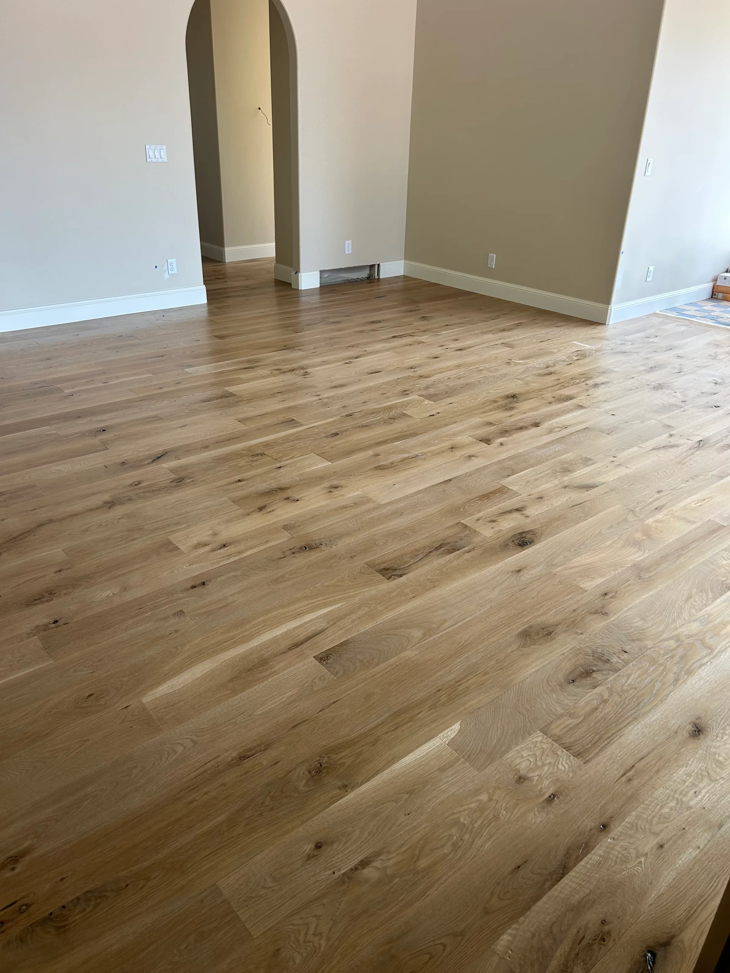 Freshly installed light white oak hardwood with natural grain character in bright residential space