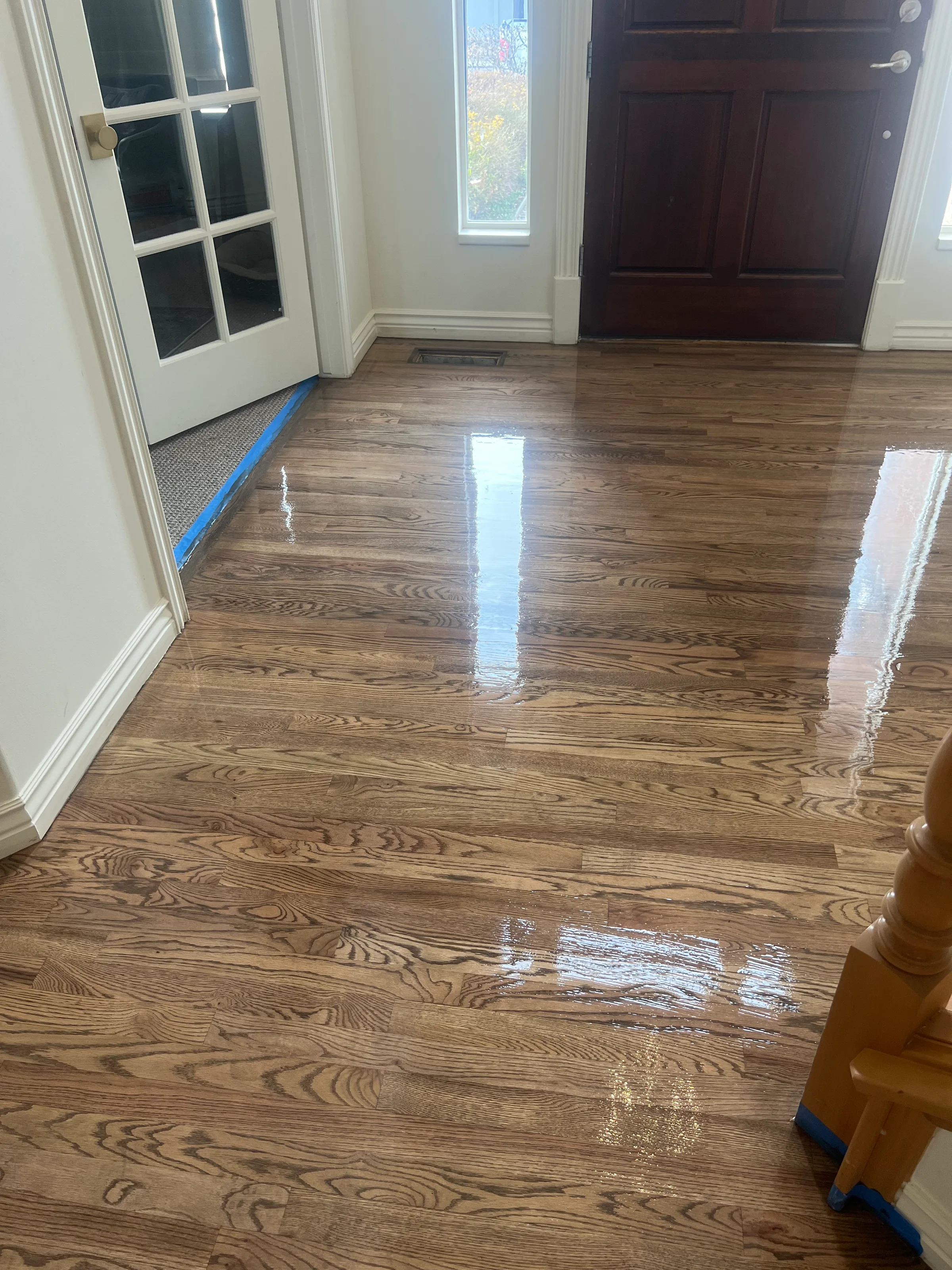 Refinished red oak flooring with warm honey tones and visible medial rays in residential interior space