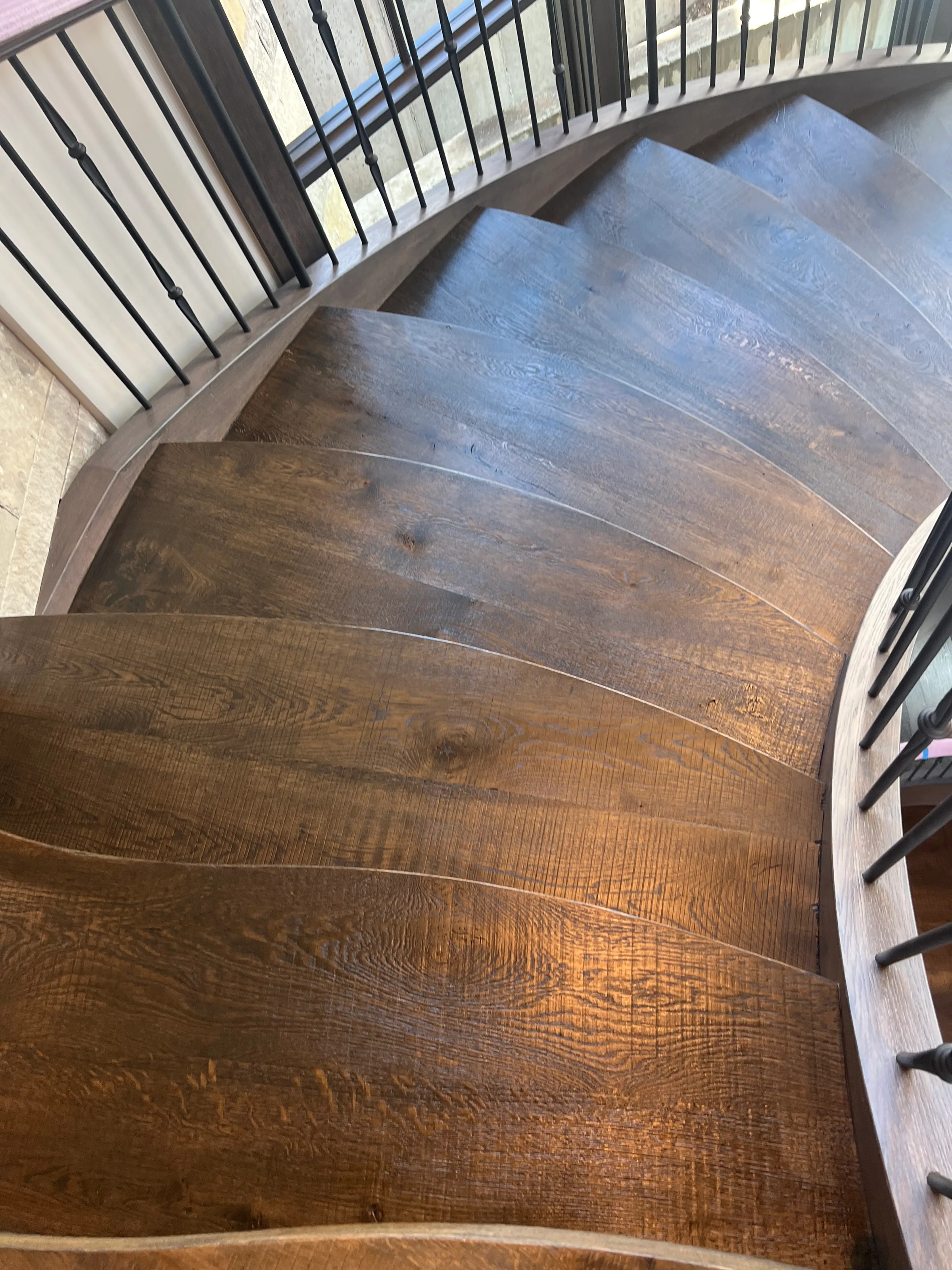 Custom white oak suspended staircase with exposed cantilever treads and modern metal railings