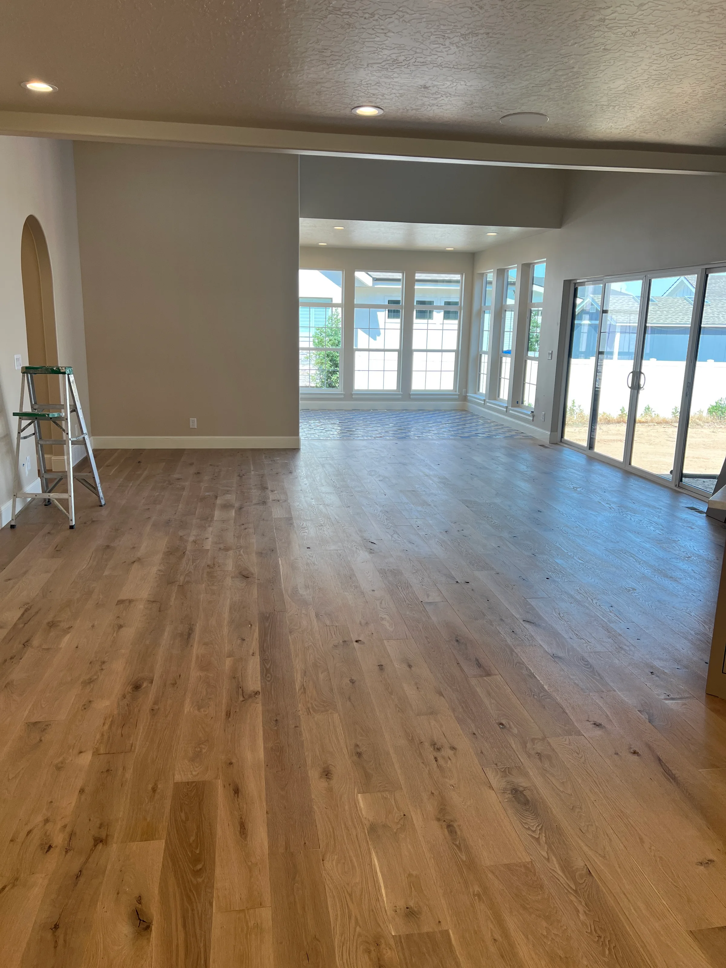 Newly installed white oak hardwood flooring in light finish with natural grain in contemporary home