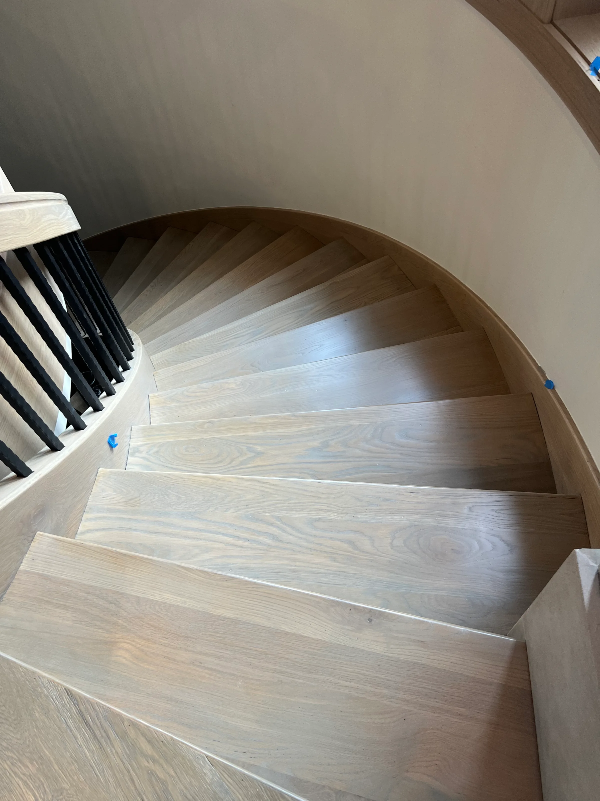 Custom built white oak staircase with squared treads and risers showing light grain character in interior space