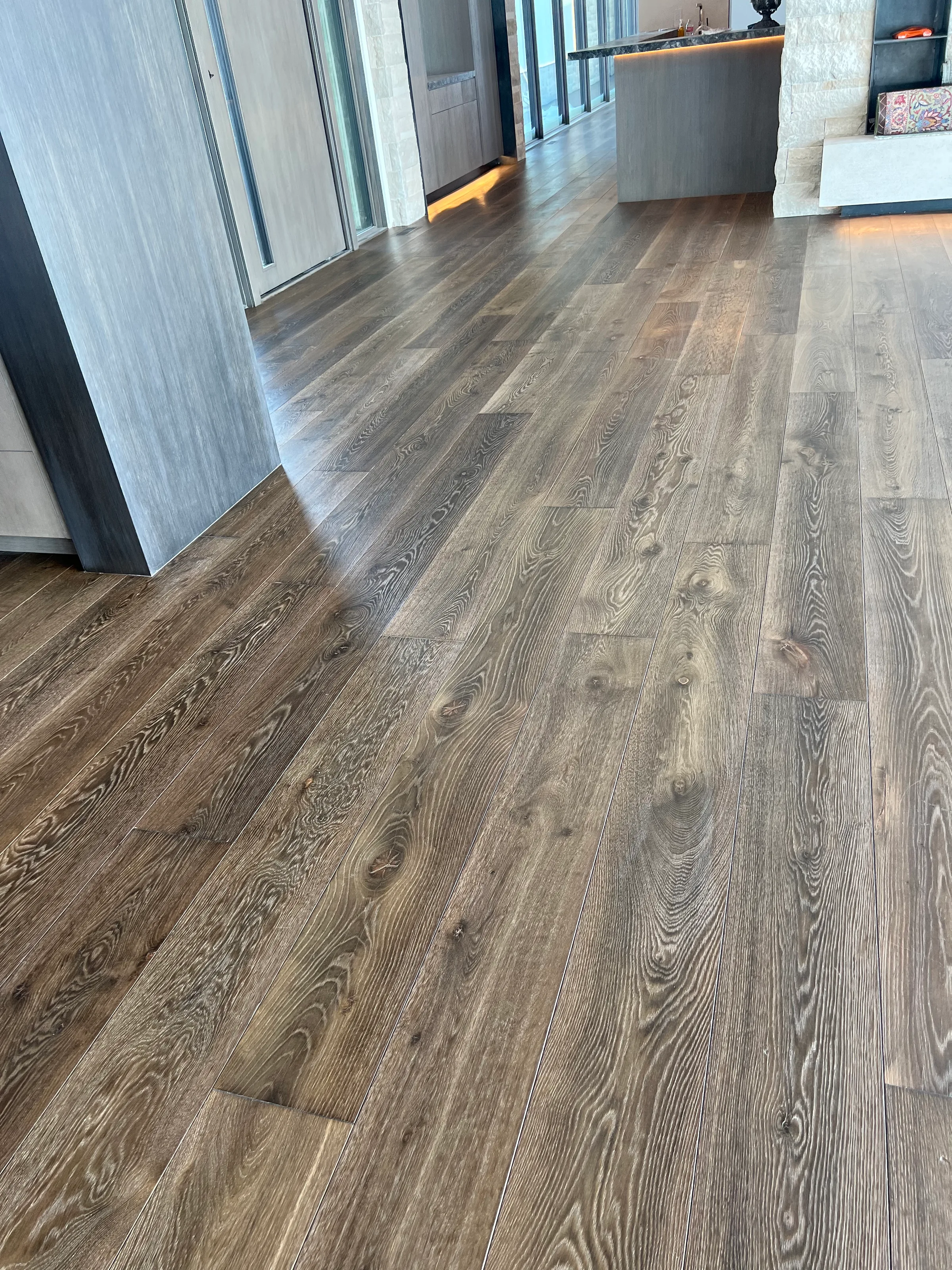 Pre-finished white oak hardwood flooring with factory finish and natural grain character in residential interior