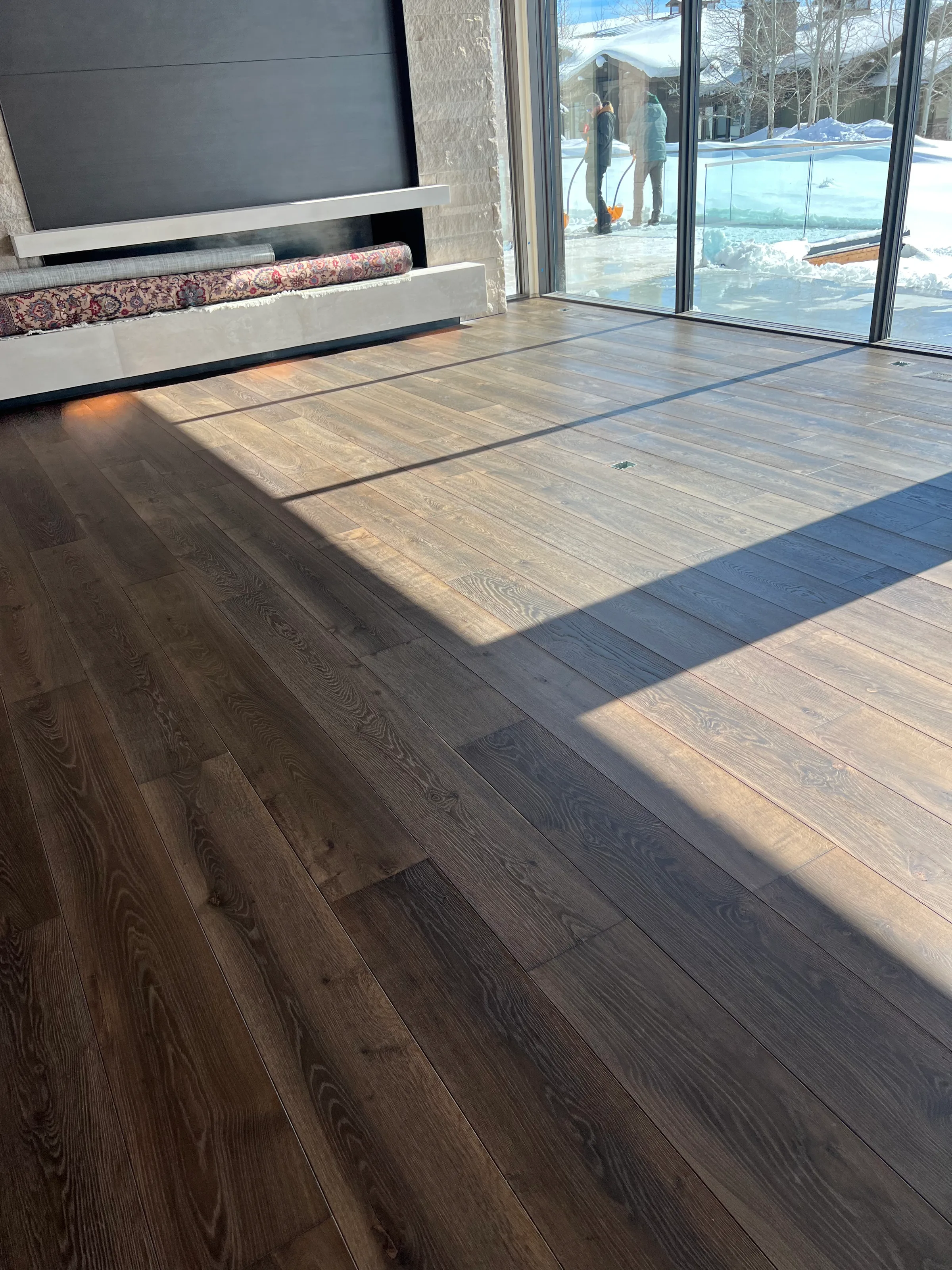 Pre-finished white oak hardwood with factory protective coating and pale grain in bright residential interior