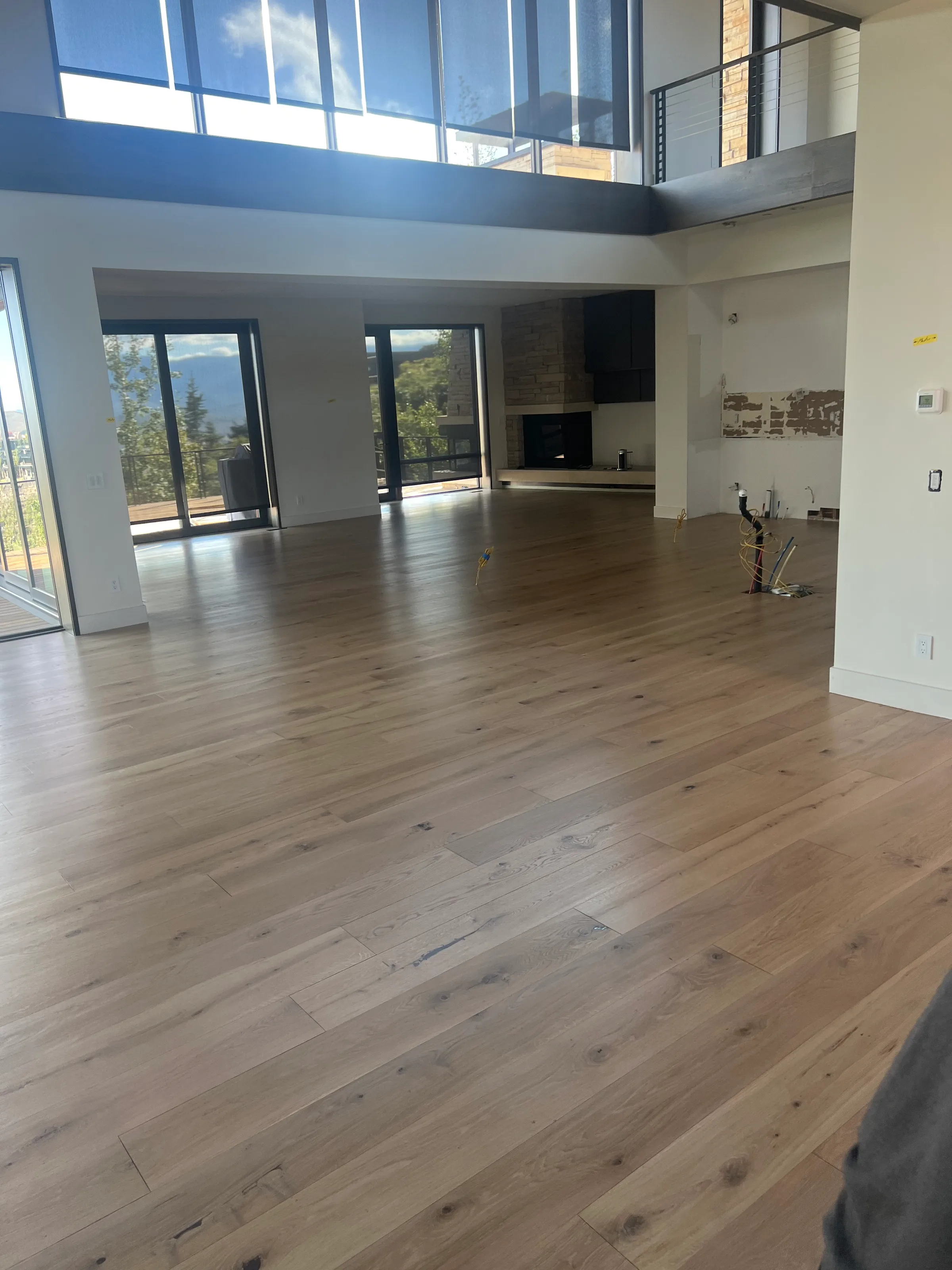 Freshly refinished white oak hardwood flooring showing rich grain and satin finish in residential space