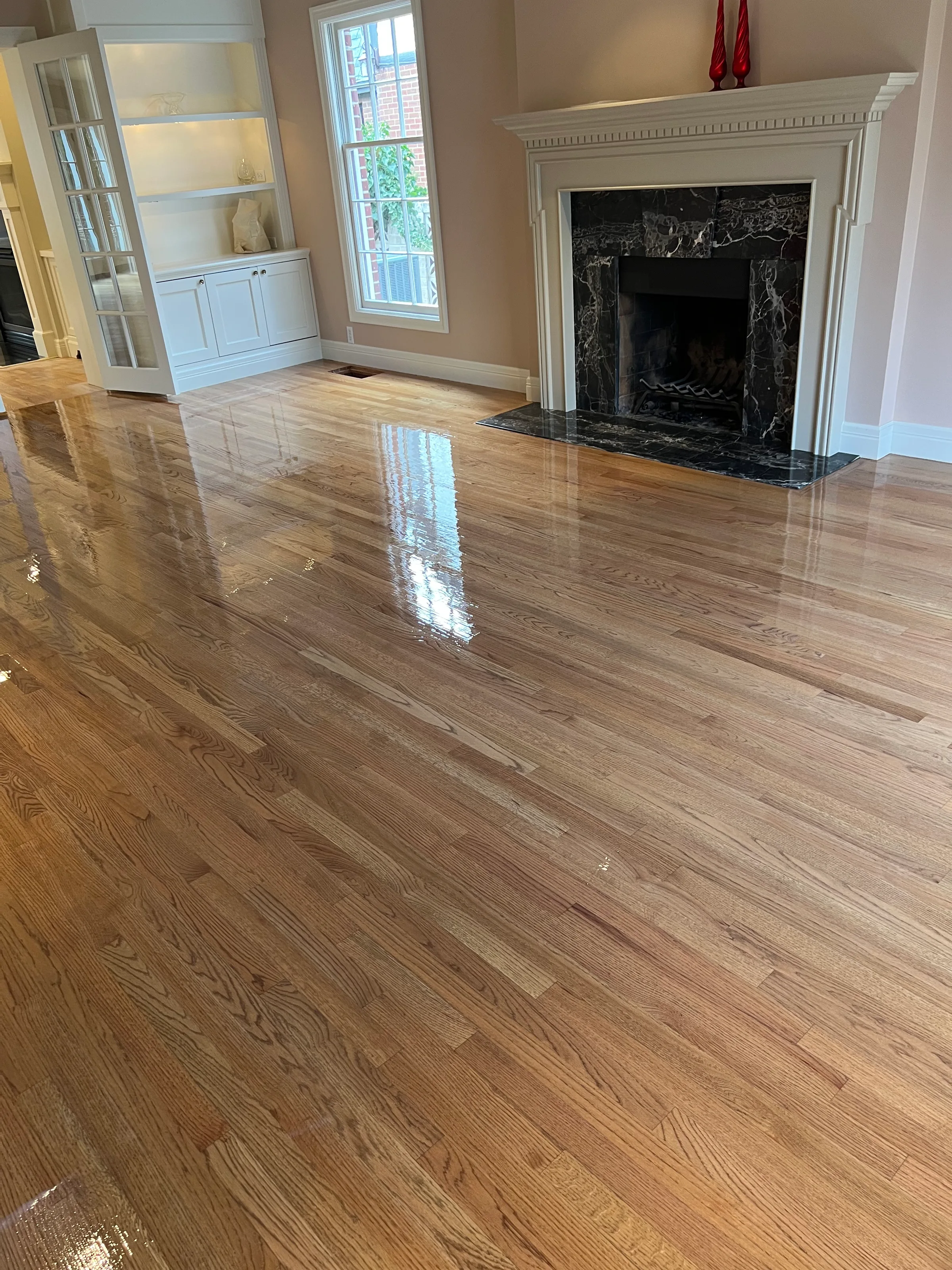 Red oak hardwood floor with full refinish, warm honey tones visible in natural light