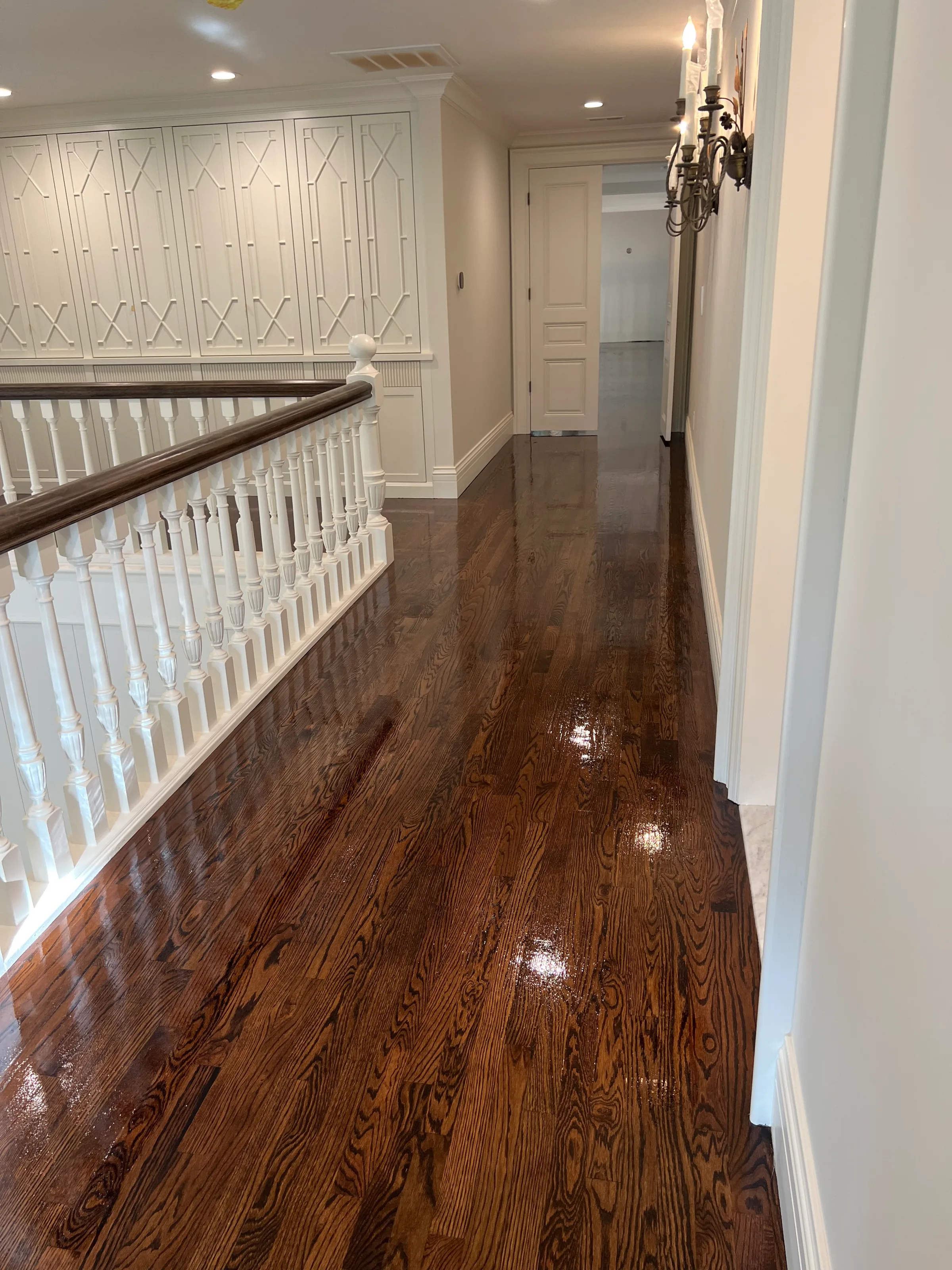 New red oak hardwood flooring installation with visible grain and natural warm tones in residential room
