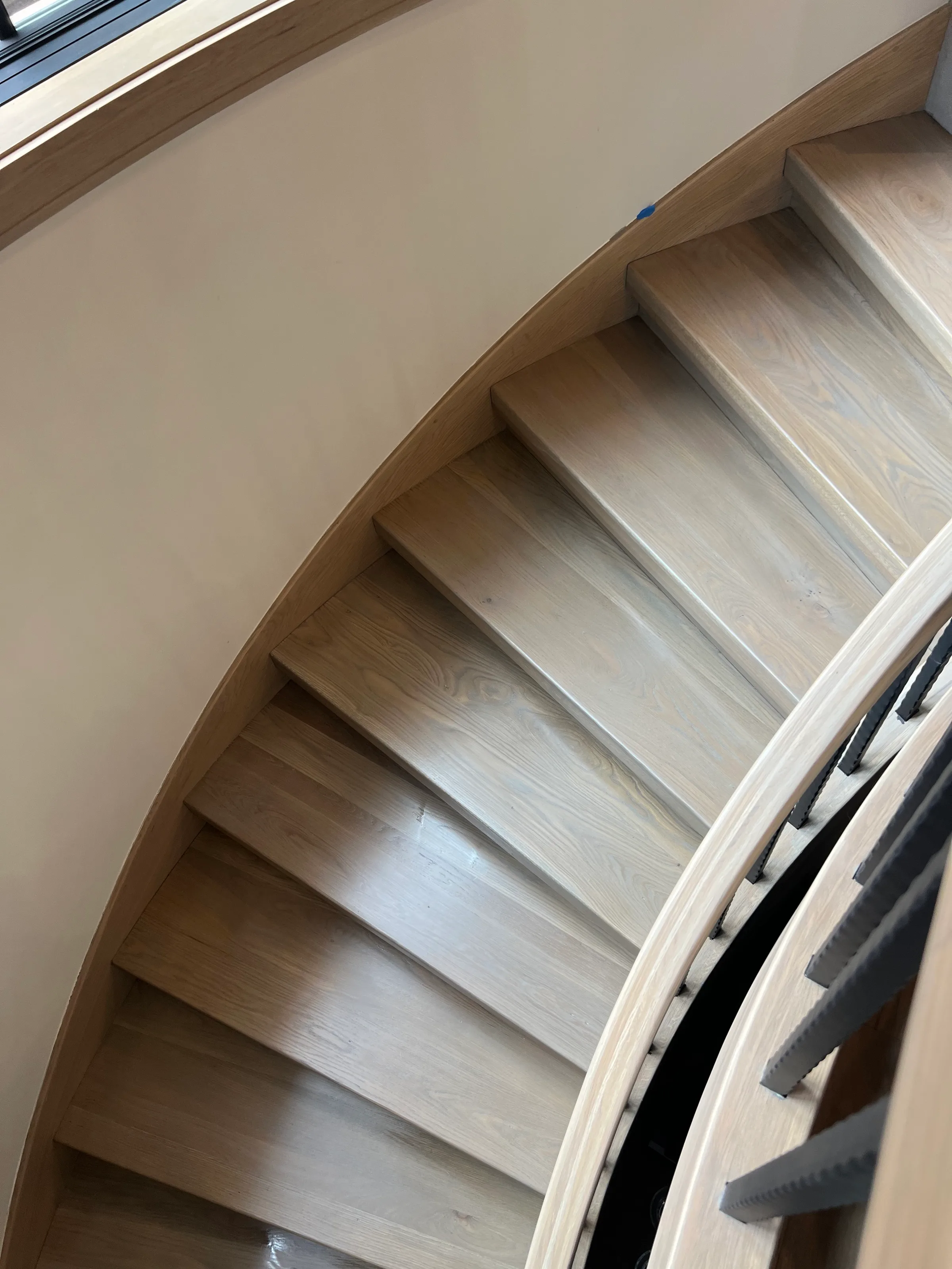 Custom built white oak staircase with squared tread and riser profile in contemporary interior space