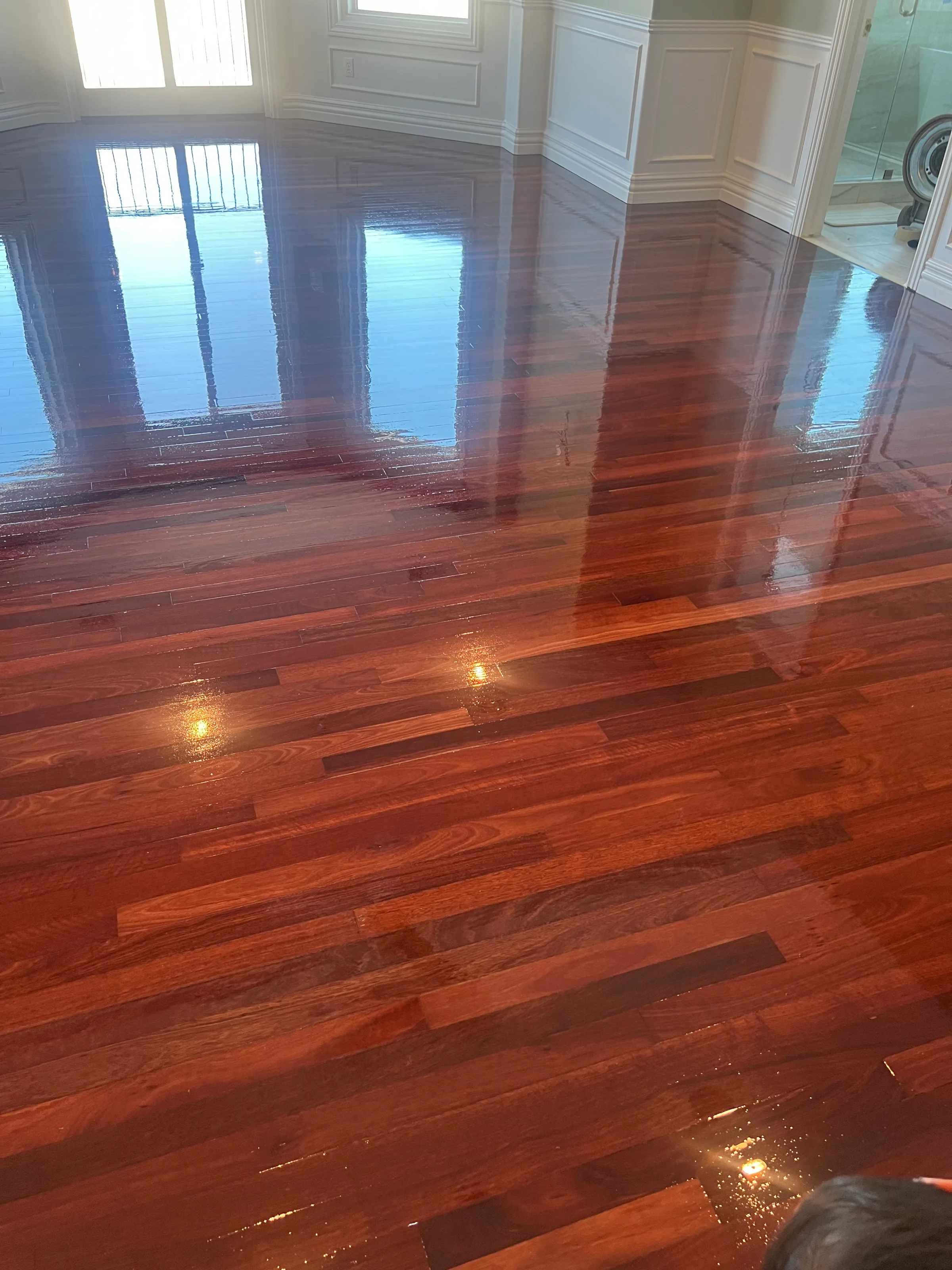 Rich reddish-brown santos mahogany hardwood with refined high-gloss finish and deep color
