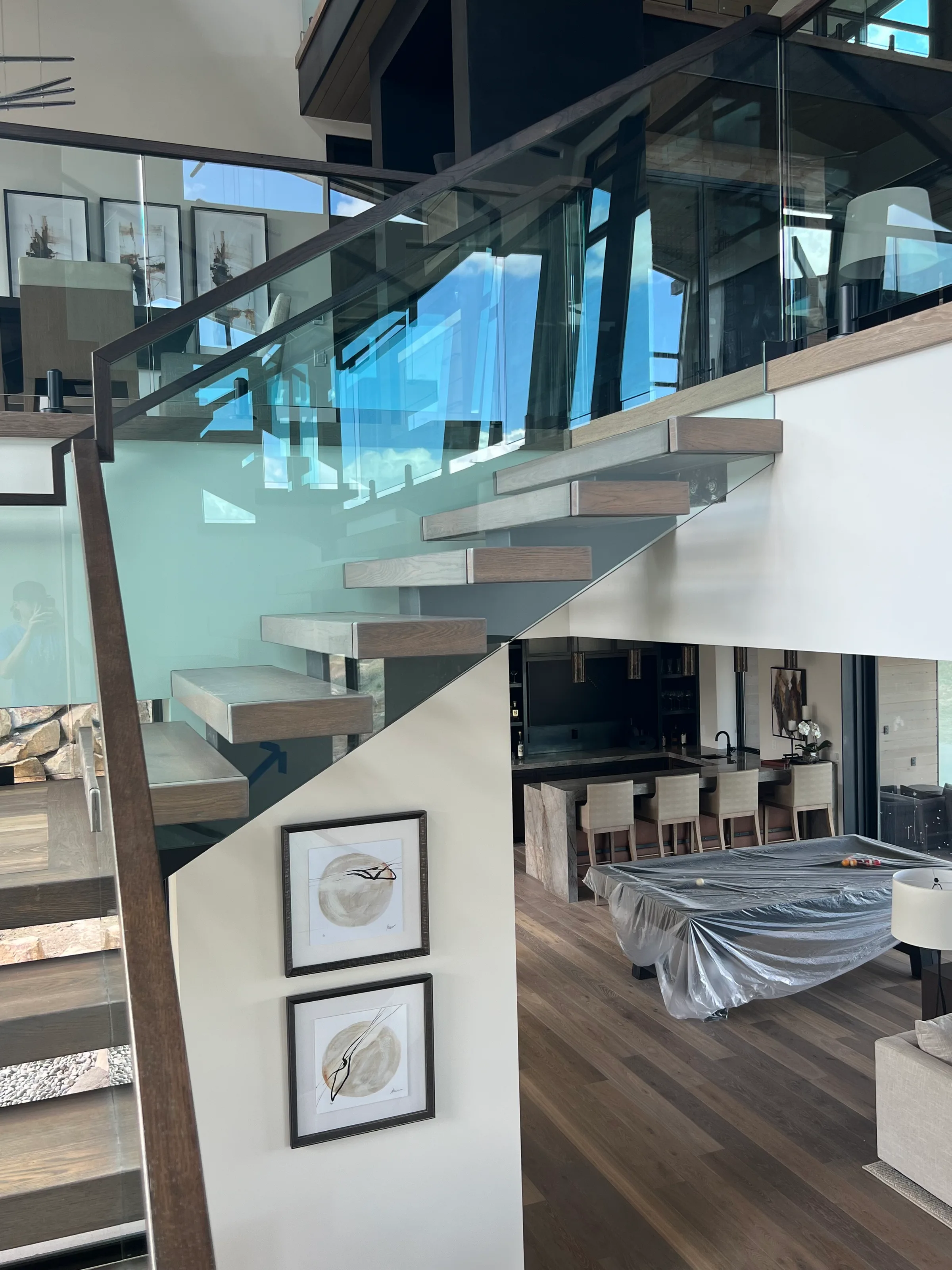 Modern white oak floating staircase with cantilever treads and geometric black metal framework
