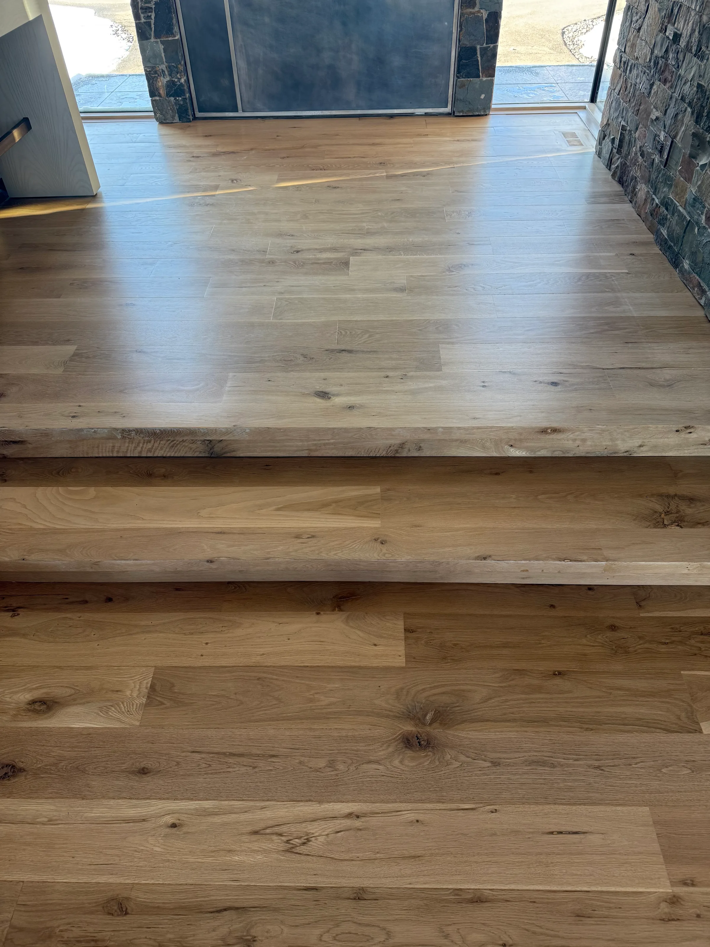 White oak wood stair treads integrated into floor with natural grain and warm finish visible