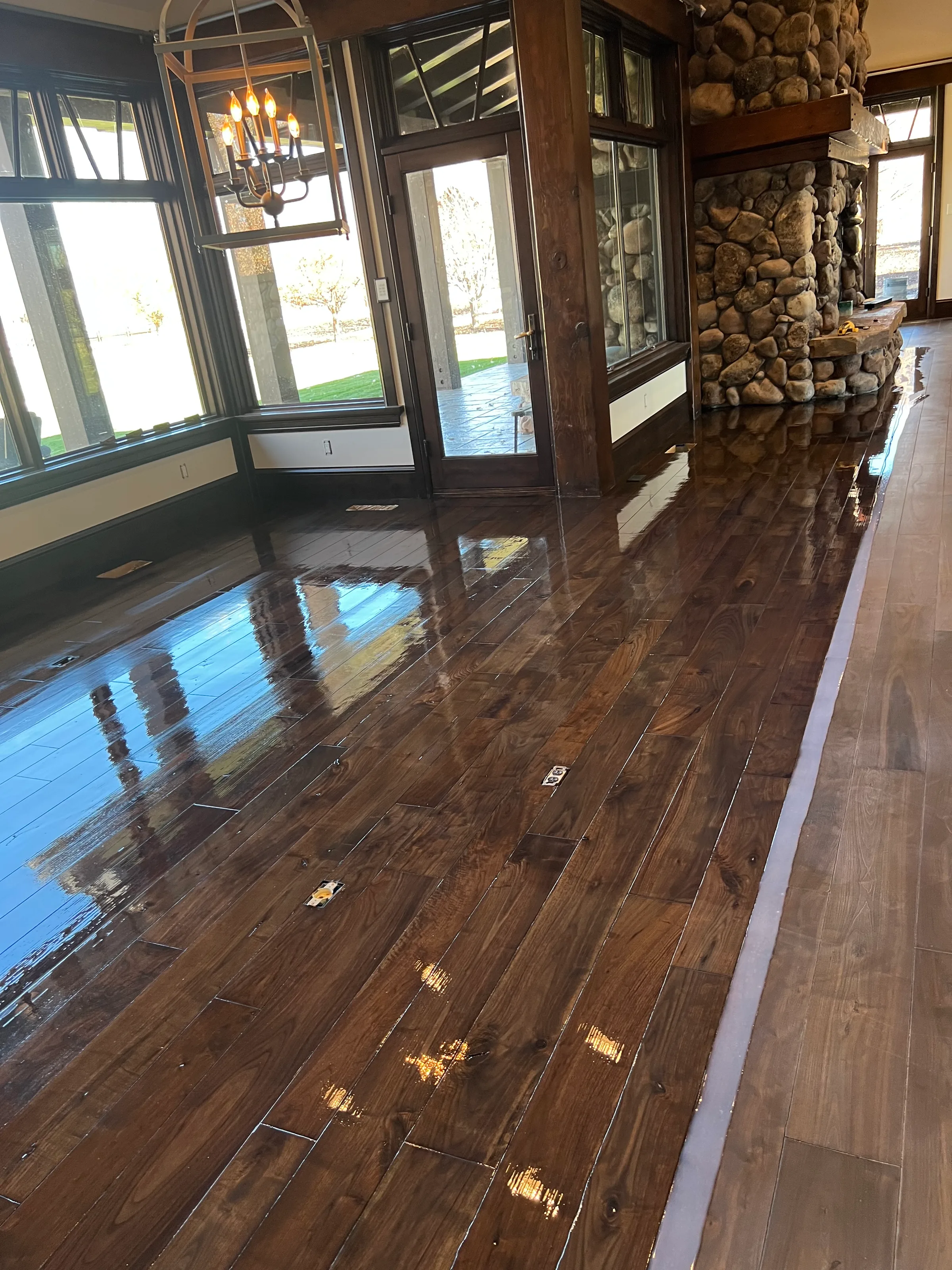 Refinished walnut hardwood with beveled edges displaying rich dark tones and natural wood character