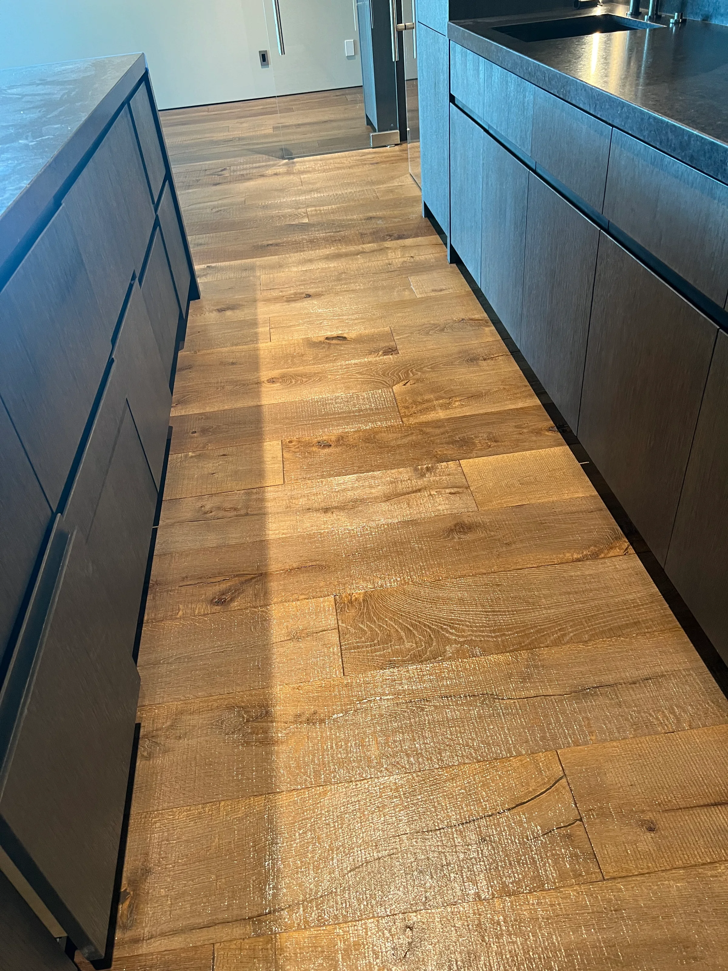 Pre-finished white oak hardwood flooring with factory finish in modern residential space with contemporary design