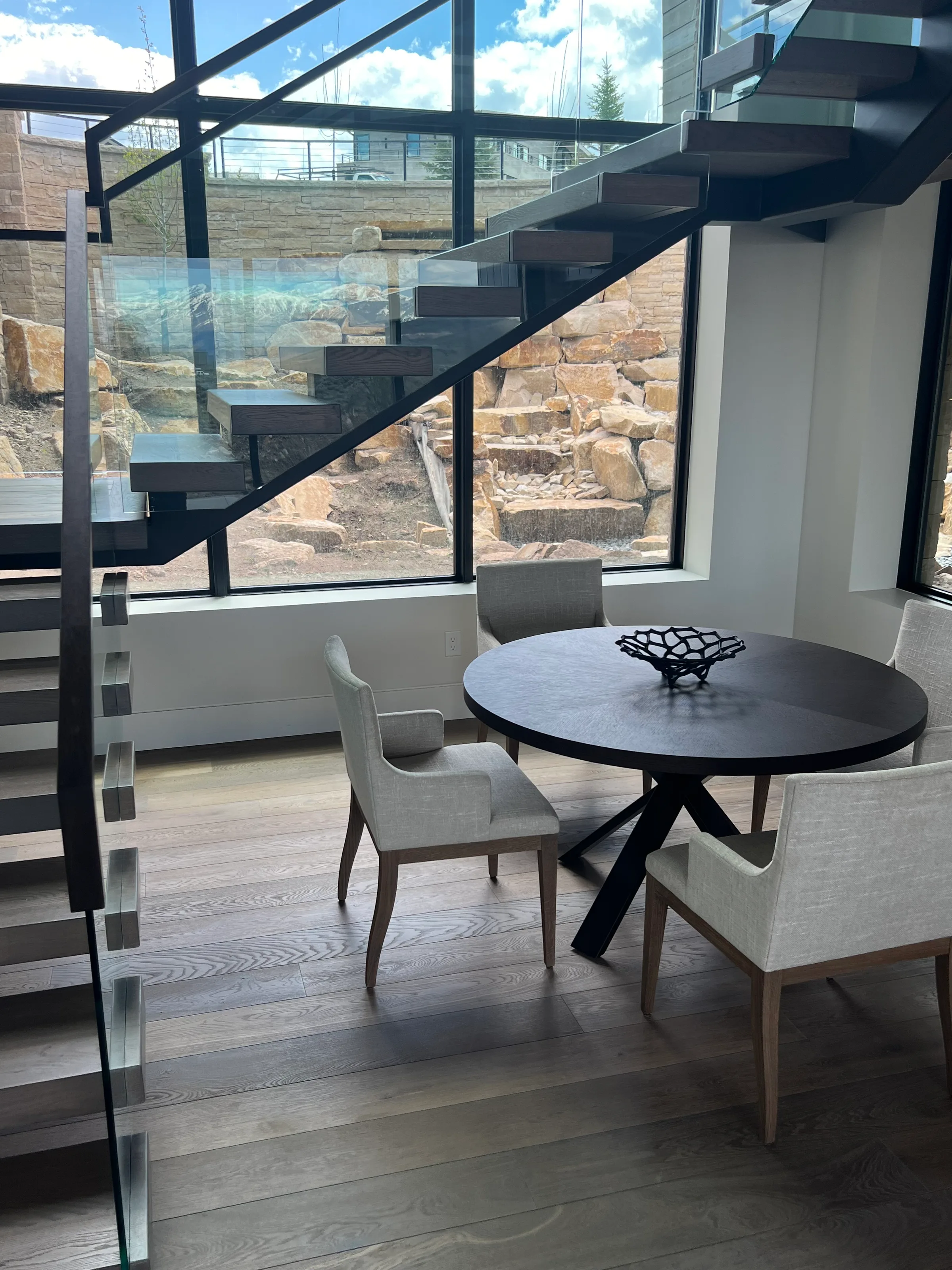 White oak cantilever staircase with suspended treads and contemporary steel railing in modern interior