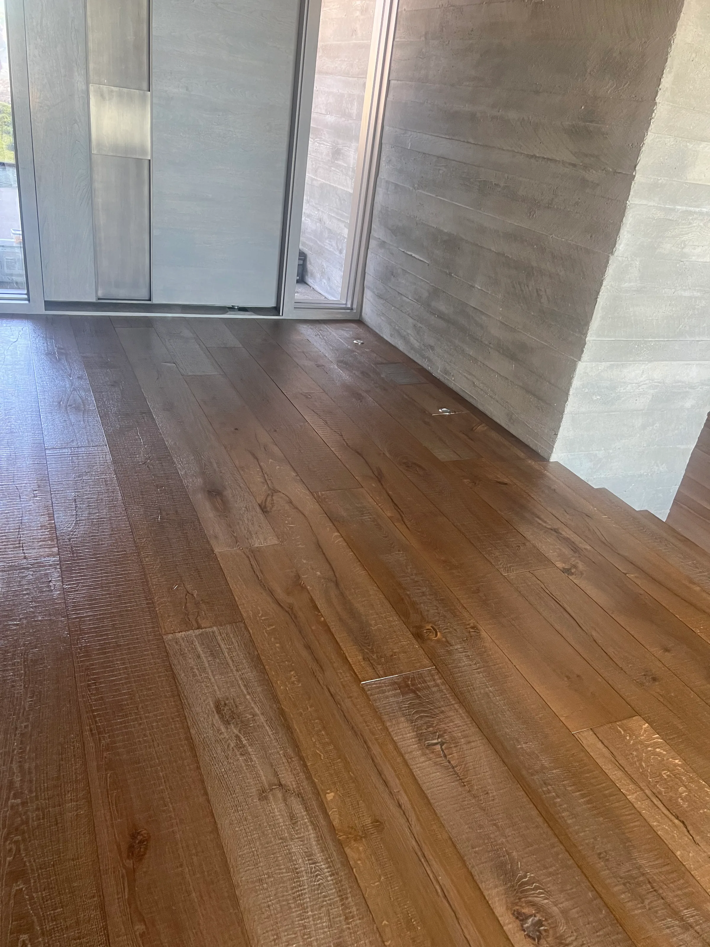 Pre-finished white oak flooring with factory finish in light-filled residential space with contemporary design